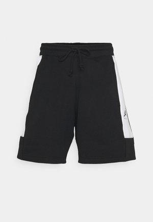 Sorte atletikshorts med hvide sidepaneler og en snøre i taljen, vist mod en ensfarvet lysegrå baggrund.
