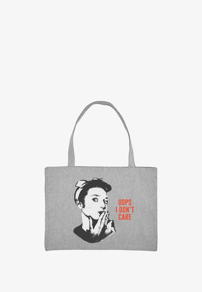 Borsa a tracolla grigia in tela con due manici; presenta un grafico in bianco e nero di un volto e il testo rosso "OOPS I DON'T CARE."