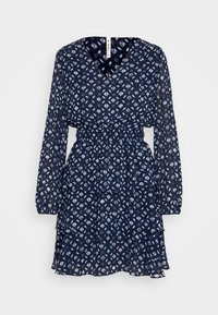 Šaty s námořnickým vzorem, dlouhými rukávy, výstřihem do V, elastickým pasem a vrstvenými volány. Obsahují bílé geometrické vzory po celé ploše.