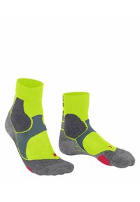 Calze a righe verdi e grigie con polsino a coste, caratterizzate da una combinazione di design solidi e a pois, e segnate da accenti rossi sulla suola.