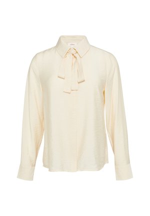 Romige, gestructureerde blouse met een kraag, strikdetail rond de hals, lange mouwen en een knoopsluiting aan de voorkant. Heeft een losse pasvorm en zachte stof.