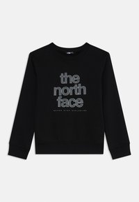 Crna dukserica s rebrastim manžetama i izrezom, s natpisom "the north face" u podebljanim bijelim slovima preko prsnog dijela. Izrađena od mekanog materijala.