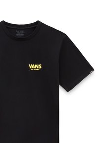 Czarna bawełniana koszulka z krótkim rękawem, z żółtym logo "VANS" oraz tekstem "OFF THE WALL" po lewej stronie klatki piersiowej. Okrągły dekolt.