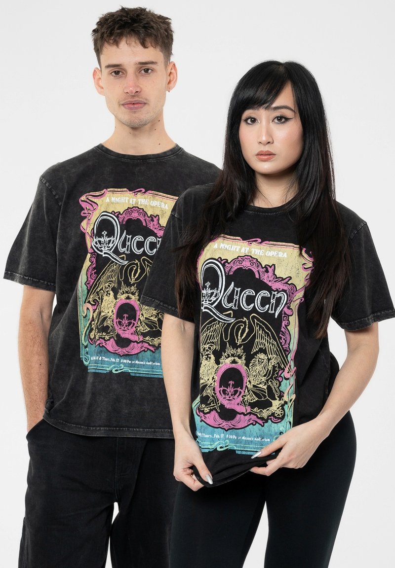 Black cotton t-shirts featuring a vintage-style graphic print of the band Queen, with colorful accents and distressed texture.