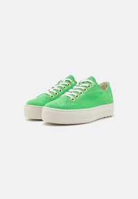 Green suede casual sneakers with white rubber sole, gold eyelets, and white laces. Low-profile design with rounded toe and textured surface.