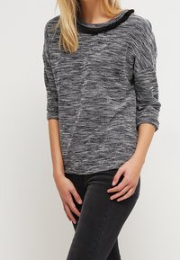 Grau und schwarz meliertes Sweatshirt mit Rundhalsausschnitt, 3/4-Ärmeln und strukturiertem Stoff. Mit einem dezenten, erhöhten Kragen Detail.