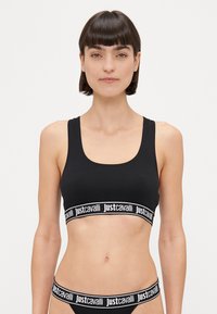 Crni pamučni bralet sa izrezom u obliku žlice, s širokom elastičnom trakom s bijelim "justcavalli" logom. Glatka tekstura, minimalni dizajn.
