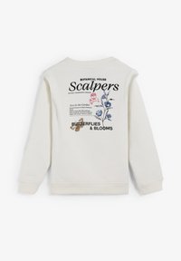 Sudadera de color crema con un diseño impreso en la parte trasera que presenta gráficos florales, texto y un detalle dorado. Mangas largas y puños acanalados.