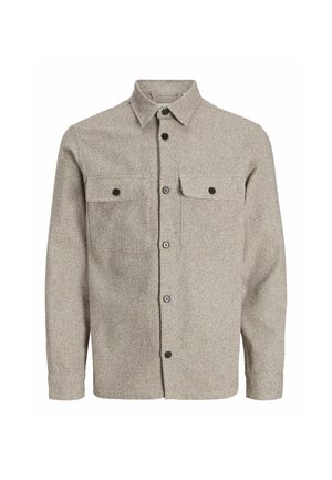 Chemise beige à manches longues, à boutons, en tissu texturé, avec deux poches poitrine à rabat et boutons, et un col classique.