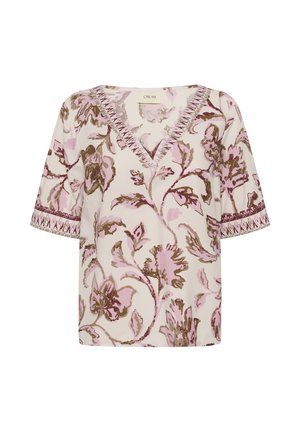 Blouse crème à col en V avec motif floral rose et marron, manches courtes et bordure décorative le long de l'encolure et des bords des manches.