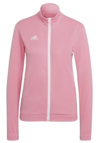 Chaqueta deportiva rosa hecha de una tela suave con un cierre zip blanco completo y cuello alto. Presenta el logo blanco de Adidas en el lado izquierdo del pecho.