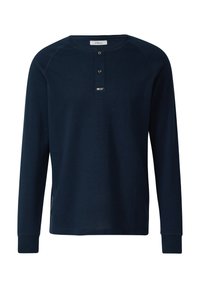 Marineblaues Langarmshirt aus strukturiertem Stoff mit rundem Ausschnitt, zweiknöpfiger Blende und verstärkten Manschetten. Verfügt über dezente Seitendetails.