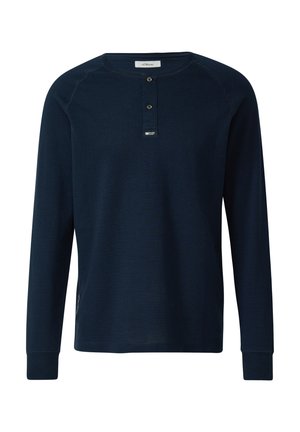 Navy long-sleeve shirt made of textured fabric with a round neckline, two-button placket, and reinforced cuffs. Features subtle side accents.