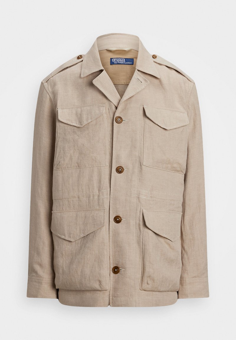 Veste en lin beige avec un col, fermeture à boutons à l'avant et quatre poches. Présente des boutons marron et des épaulettes. Tissu texturé.