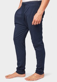 Pantalons jogger bleu marine en mélange de coton, dotés d'une taille élastique avec cordon de serrage et jambes fuselées avec coutures latérales.