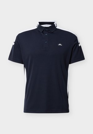Polo de manga corta color azul marino con rayas blancas en los hombros, tapeta de tres botones y pequeño logo blanco en el pecho izquierdo.