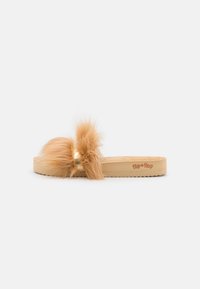 Faux fur slide sandal in light tan, featuring a plush band and a textured sole with a floral pattern. "Flip flops" logo printed on the footbed.