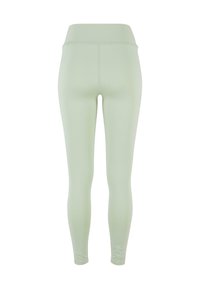 Leggings vert clair avec une taille haute. Texture lisse, design ajusté et sans motifs ni accents visibles.