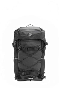 Black backpack with textured fabric, adjustable straps, front zipper pocket, and elastic cord detail. Features logo on lower front.