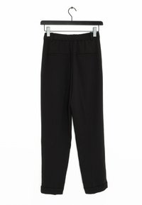Black pants with a relaxed fit, featuring a soft fabric, elastic waistband, flat front pockets, and rolled cuffs at the hem.
