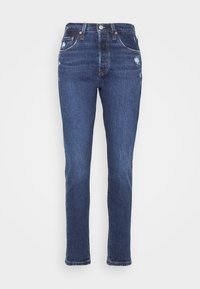 Mörkblå denimjeans med rak ben, med lätt slitning, femfickorsdesign och knappgylf.