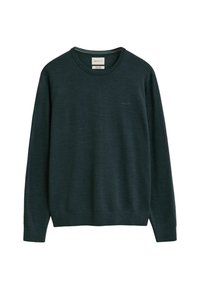 Pull en maille vert foncé avec un col rond et des manches longues. Présente un logo discret sur la poitrine ainsi que des bords côtes aux poignets et à l'ourlet.