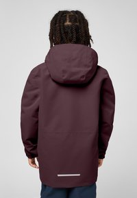 Bordeauxfarbene wasserdichte Jacke mit Kapuze, langen Ärmeln, elastischen Bündchen und reflektierendem Streifen am Saum. Glatte, matte Oberfläche.