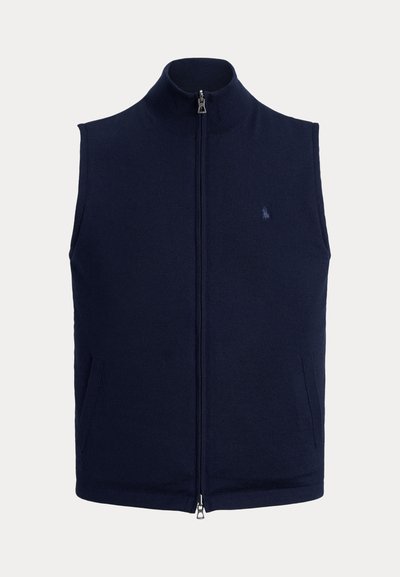 Tumši zila bezvēdera veste ar rāvējslēdzēju, augstu apkakli un smalku izšūtu logotipu kreisajā krūšu daļā.