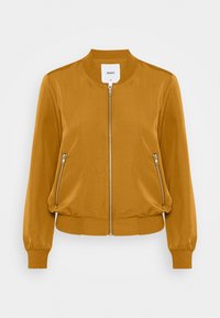 Bomberka w musztardowym kolorze z okrągłym kołnierzem, z zapięciem na zamek z przodu i dwoma bocznymi kieszeniami na zamek. Gładki materiał z elastycznymi mankietami i paskiem w talii.