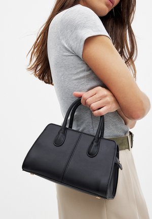 Black rectangular handbag with double handles, made of smooth leather. Features visible stitching and a simple design without embellishments.