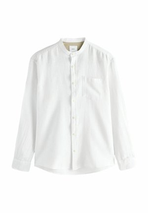 Chemise blanche à manches longues avec un col boutonné, une poche au front et un tissu texturé. Comprend des boutons discrets et un ourlet arrondi.