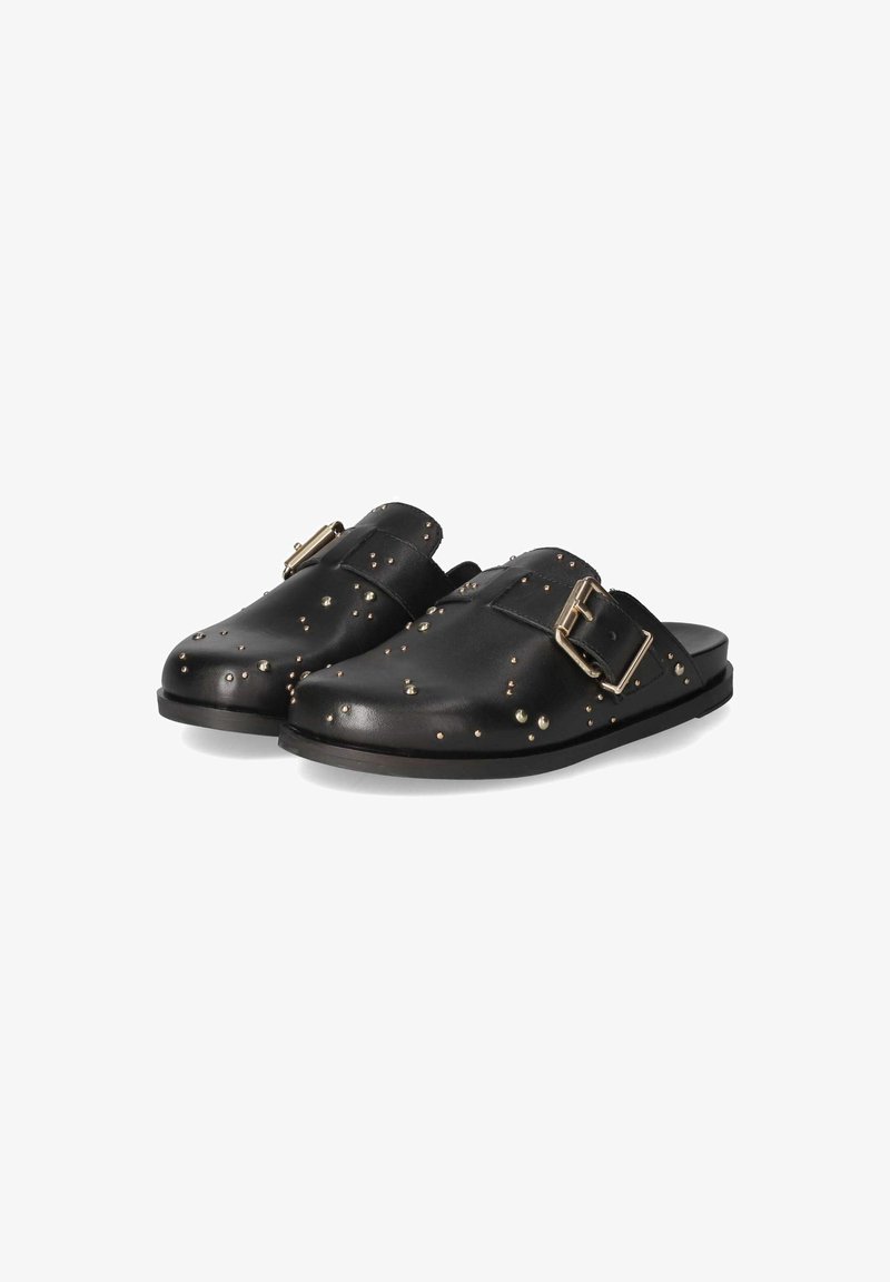 Black leather mules with a rounded toe, adorned with decorative studs and a gold-tone buckle on the side. Flat rubber sole, textured surface.