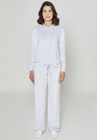 Hoodie bleu clair avec cordons de serrage, assorti à un pantalon à cordons de serrage avec logo. Tissu doux, coupe décontractée et manches longues.