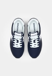 Navy running shoes with white accents, mesh textile upper, round toe, flat rubber sole, and lace-up design. Brand name "Saucony" on tongue.