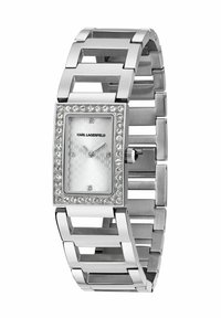 Silberne rechteckige Uhr mit strukturiertem weißem Zifferblatt, umgeben von einer Kristall-Lünette und einem klobigen Gliederarmband-Design.