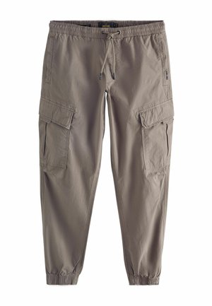 Pantalones cargo de tela marrón claro, con dos bolsillos laterales, cinturilla elástica con cordón y puños elásticos en los tobillos.