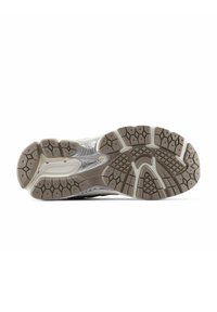 Gray athletic shoe sole featuring a durable rubber material, textured surface with varying tread patterns, and a smooth midsole.