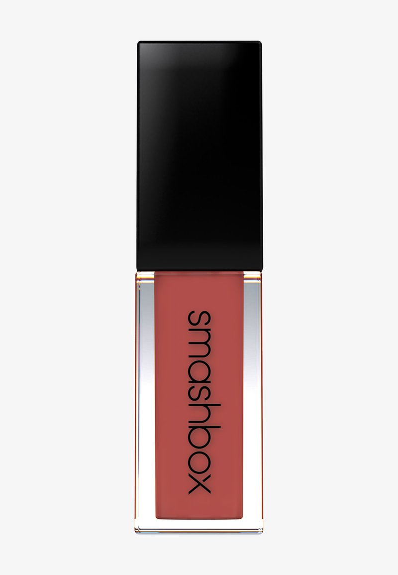 Liquid lipstick in a rectangular clear container with a black square cap. The shade is a muted rose hue, featuring a smooth texture.