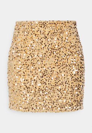 Mini-jupe dorée entièrement recouverte de petits sequins brillants, créant une surface scintillante et texturée.