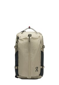 Sac à dos rectangulaire beige et noir avec poche zippée à l'avant, sangles latérales ajustables et poigné tressé à l'étiquette "Swiss Seil."