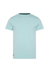 Svetlo modra bombažna majica s krožno izreza in kratkimi rokavi. Ima minimalen dizajn z majhnim etiketom na levi strani.