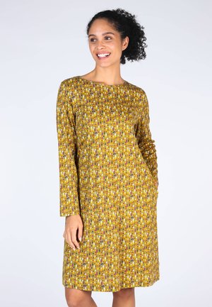 Langärmliges Kleid aus senfgelbem Stoff mit einem geometrischen Muster aus bunten Ovalen. Das Design hat einen runden Halsausschnitt und seitliche Taschen.