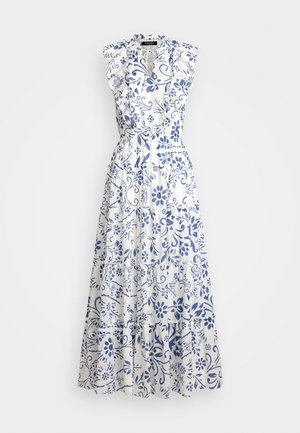 Robe maxi florale en coton blanc avec motifs bleus, manches volantées, col en V et détail de jupe à volants. Ceinture élastique pour un ajustement parfait.
