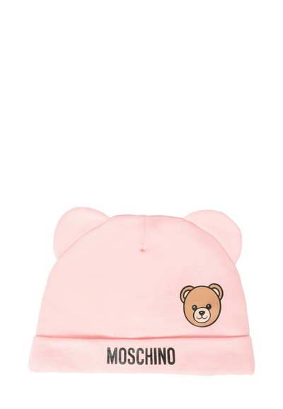 Vaaleanpunainen puuvillapipo, jossa on karhunkorvat, karhukuva ja "MOSCHINO" -logo resorissa. Sileä pinta, yksinkertainen muotoilu.