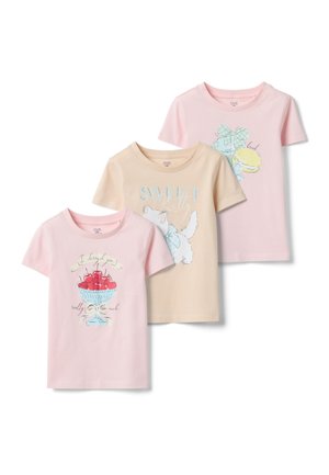 Drie kindsshirts met korte mouwen in pastelroze en beige, elk met verschillende kleurrijke prints: kersen, een kat en macarons met een strik.