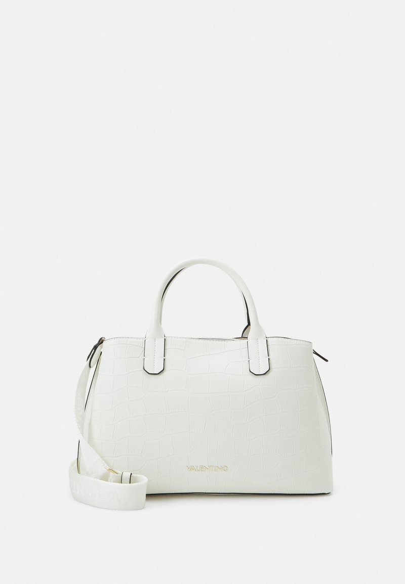 White leather handbag with a crocodile texture, structured shape, dual handles, gold logo, and adjustable shoulder strap.