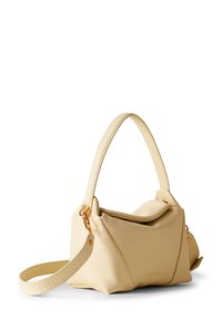 Cream leather handbag with a unique, structured design. Features a short handle and an adjustable strap, accented with gold hardware.