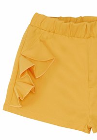 Yellow fabric shorts with an elastic waistband and ruffled accents on the side, featuring a smooth texture and clean stitching details.