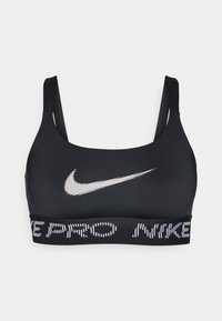Czarny sportowy stanik z cienkimi ramiączkami. Na przodzie znajduje się białe logo Nike oraz elastyczny pasek z napisem "PRO NIKE". Gładka tekstura.