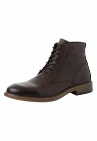 Bottes chelsea en cuir marron avec une texture lisse, bout arrondi et laçage à l'avant. Caractéristiques : un talon en bois et un logo discret sur le côté.